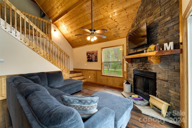 living room featuring wood ceiling, ceiling fan, hardwood / wood-style flooring, a fireplace, and lofted ceiling