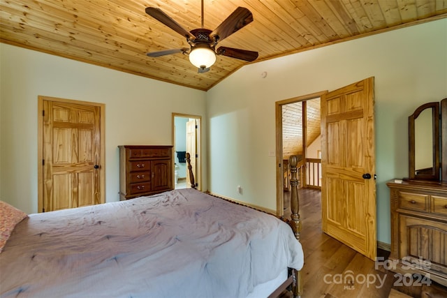 bedroom featuring lofted ceiling, ceiling fan, ornamental molding, light hardwood / wood-style floors, and wood ceiling