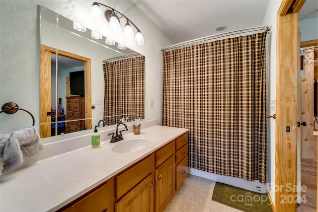 bathroom featuring tile patterned flooring, vanity, and a shower with curtain