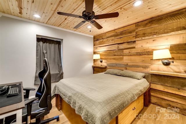 bedroom featuring ceiling fan, wood ceiling, crown molding, and wooden walls