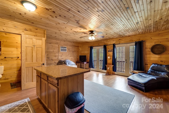 interior space featuring ceiling fan, wooden walls, and wood ceiling