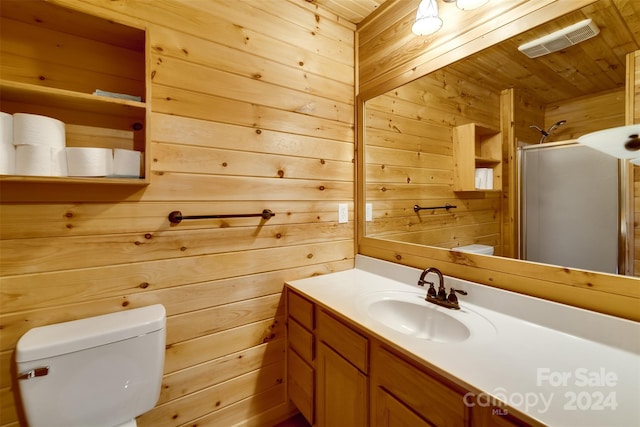 bathroom featuring wood walls, vanity, wood ceiling, and toilet