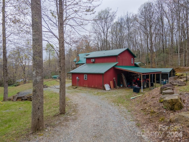 view of property exterior with an outbuilding