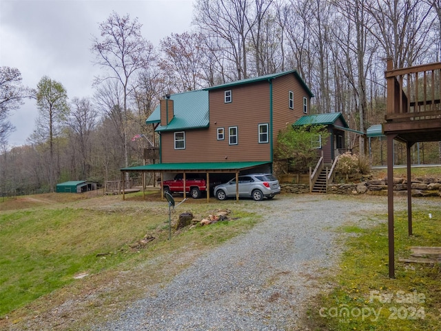 view of side of property featuring a yard and a carport