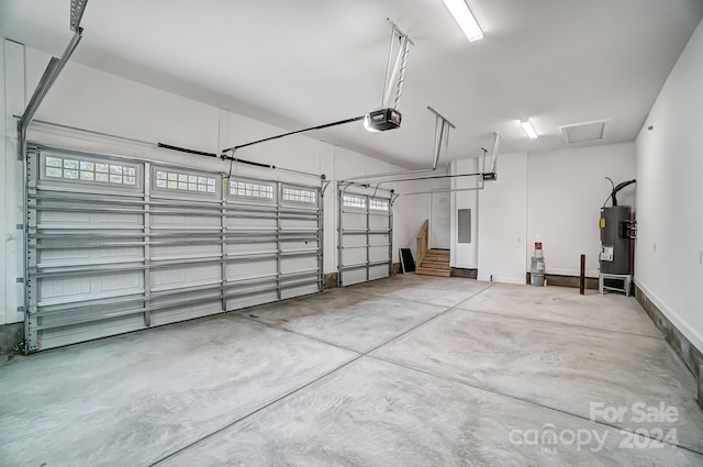 garage with electric panel, electric water heater, and a garage door opener