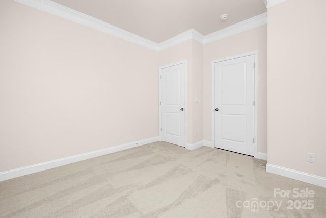 unfurnished room featuring light carpet and crown molding