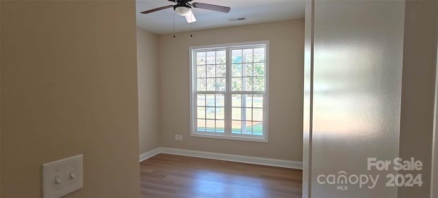 spare room featuring ceiling fan and hardwood / wood-style floors