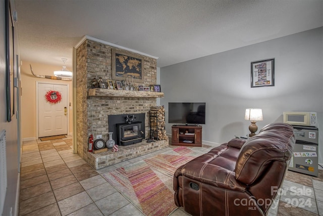 living room featuring a wood stove, light tile patterned floors, and a textured ceiling