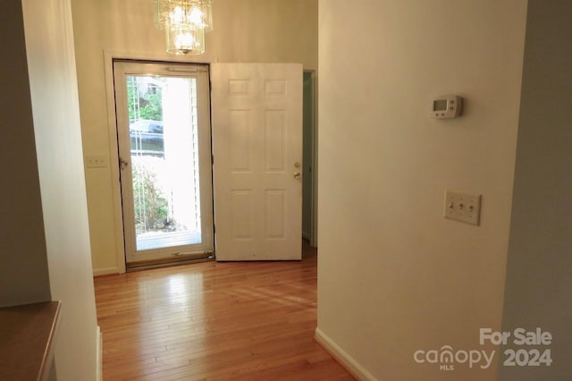 entryway with a chandelier and light wood-type flooring