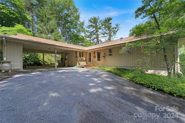 single story home featuring a carport