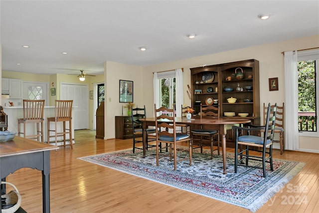 dining space featuring light wood-type flooring, ceiling fan, and plenty of natural light