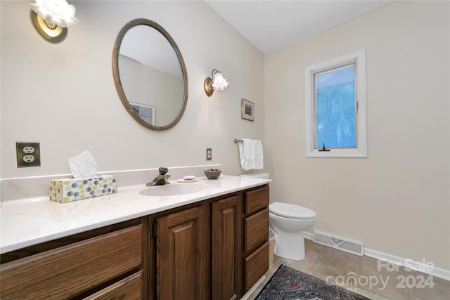 bathroom with tile patterned floors, vanity, and toilet