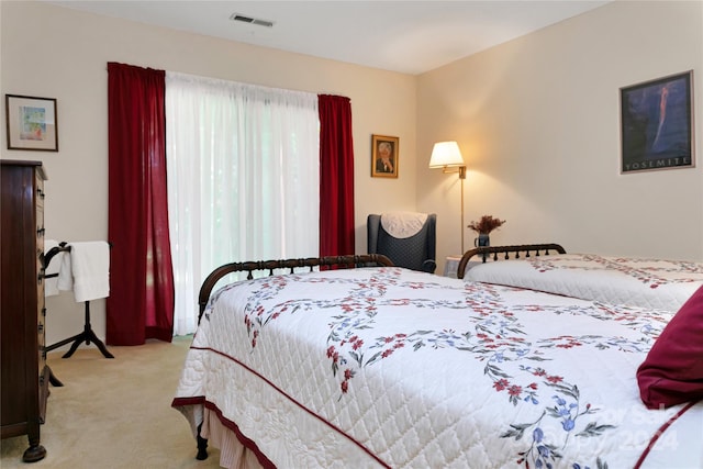 bedroom with light colored carpet