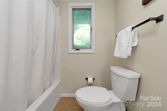 bathroom with toilet and shower / bath combo