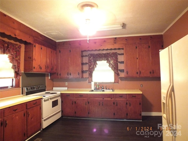 kitchen with sink, dark wood-type flooring, white appliances, and ornamental molding