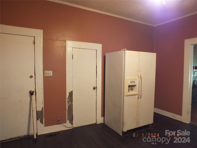 kitchen featuring white refrigerator with ice dispenser, dark wood-type flooring, and ornamental molding