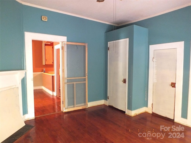 unfurnished bedroom with crown molding and dark hardwood / wood-style floors