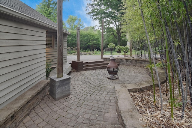 view of patio / terrace with an outdoor fire pit and a wooden deck