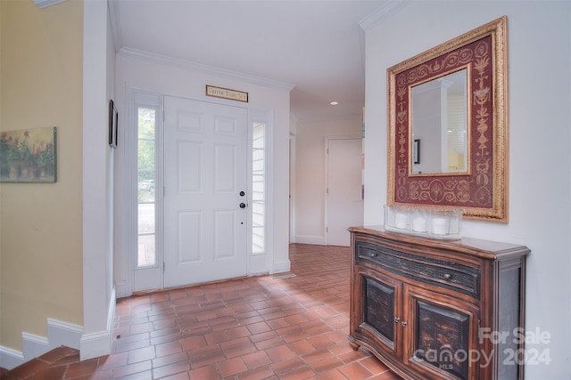 entrance foyer with crown molding and tile patterned floors