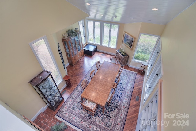 living room featuring dark hardwood / wood-style floors and a high ceiling