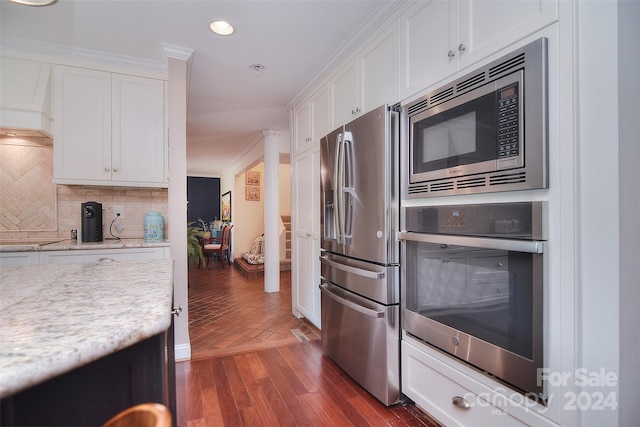 kitchen with white cabinets, light stone countertops, and stainless steel appliances