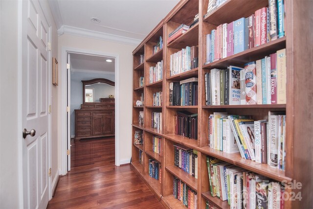 hall with dark hardwood / wood-style floors and crown molding