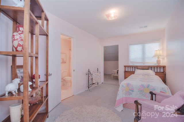 carpeted bedroom featuring ensuite bathroom