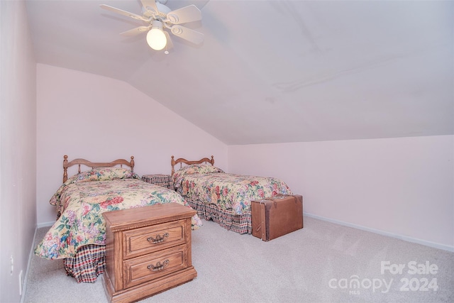 carpeted bedroom featuring vaulted ceiling and ceiling fan