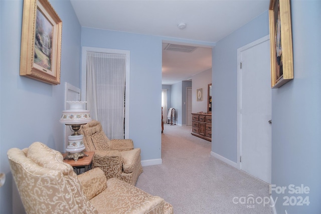 sitting room with light colored carpet