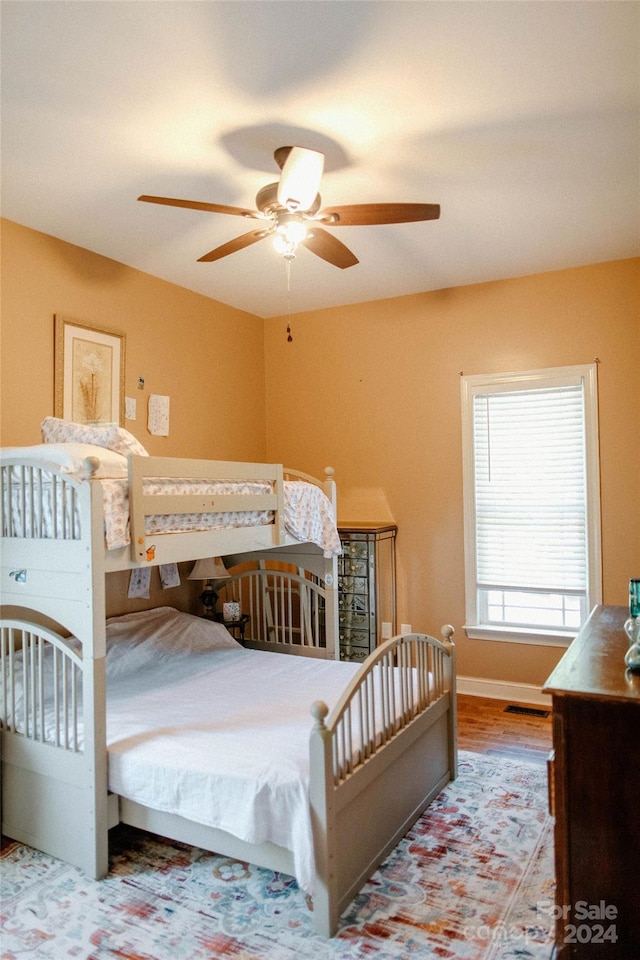 bedroom featuring ceiling fan and hardwood / wood-style floors