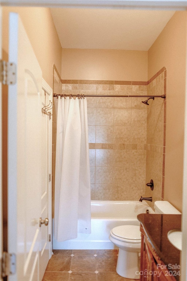 full bathroom featuring toilet, vanity, tile patterned flooring, and shower / bath combination with curtain