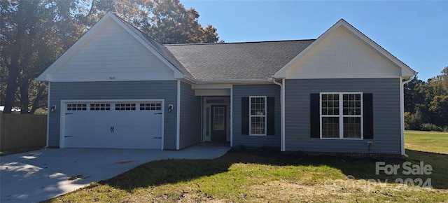 view of front of house featuring a front lawn and a garage