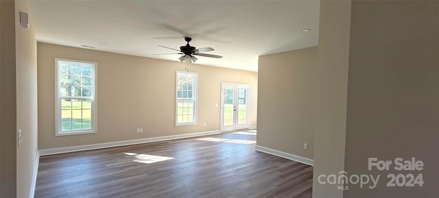 spare room with dark wood-type flooring, ceiling fan, and french doors