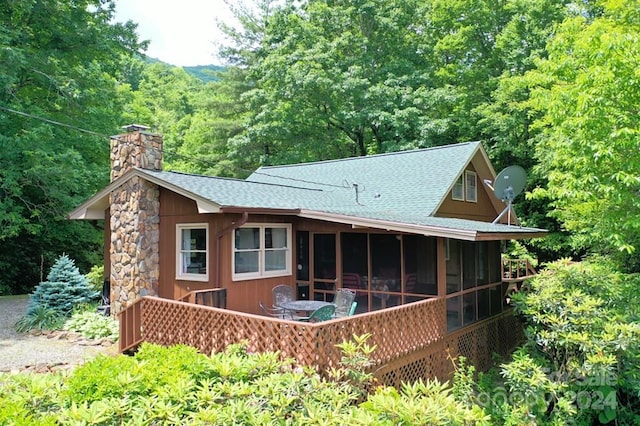 rear view of property with a sunroom