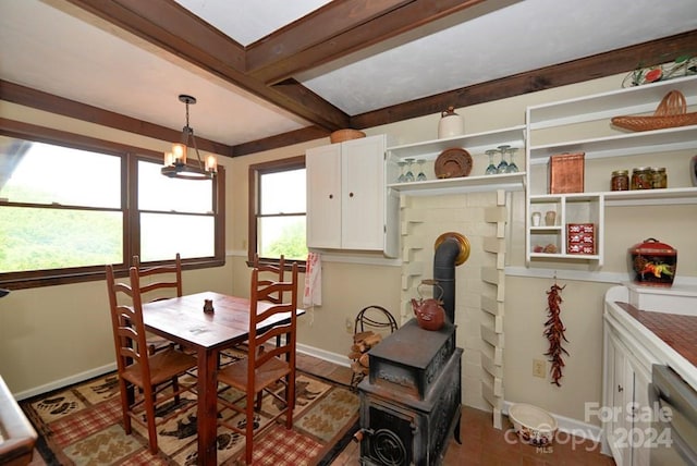 tiled dining space featuring beam ceiling and a wood stove