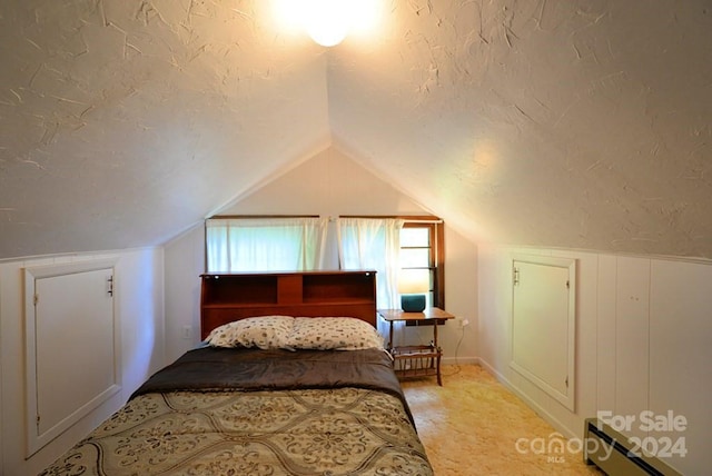 bedroom with a textured ceiling, lofted ceiling, light colored carpet, and a baseboard radiator