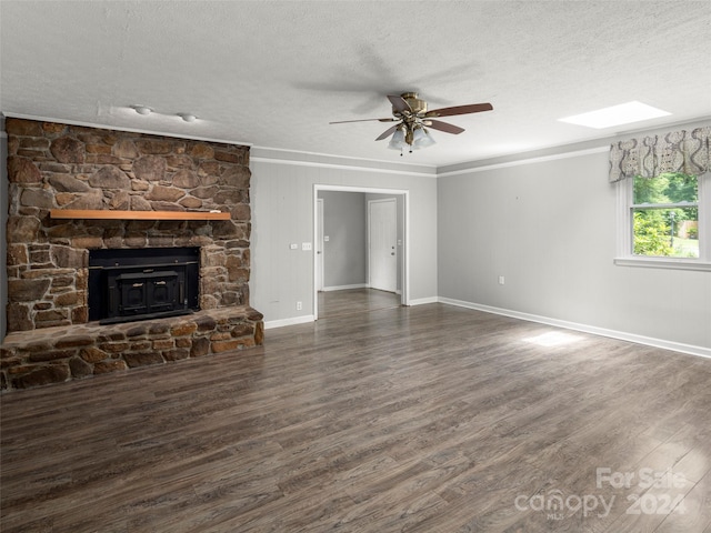 unfurnished living room with a fireplace, a textured ceiling, ceiling fan, and dark hardwood / wood-style flooring