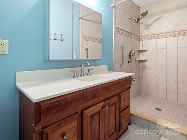 bathroom featuring vanity, tiled shower, and tile patterned floors