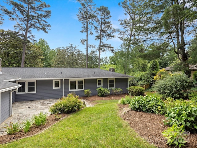 back of house featuring a patio and a yard