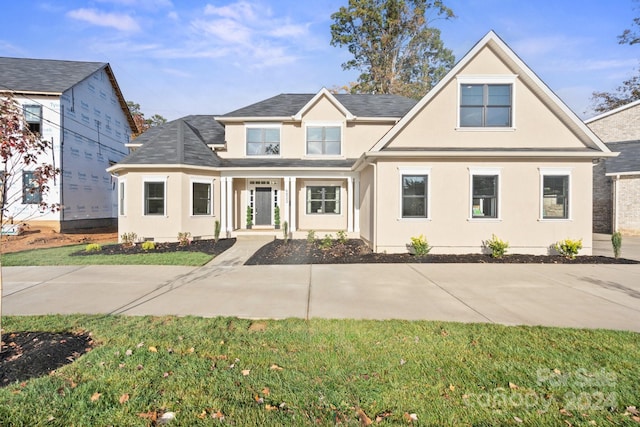 4023 Randolph Rd, Charlotte, NC 28211 - view of front of house featuring stucco siding, a front lawn, and a porch