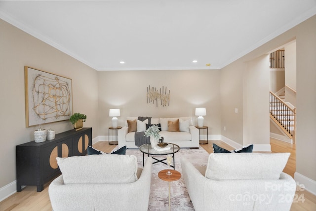 living room with light hardwood / wood-style flooring and crown molding