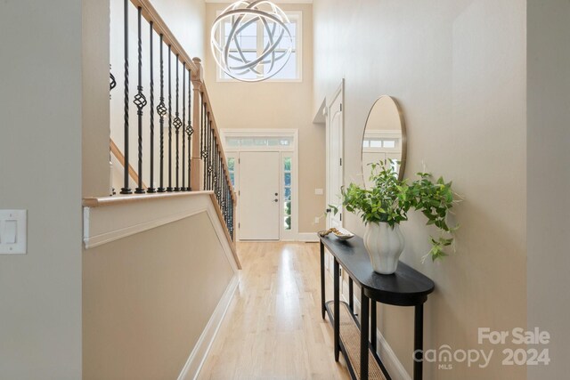 4023 Randolph Rd, Charlotte, NC 28211 - entrance foyer with light wood-style floors, stairs, a towering ceiling, and baseboards