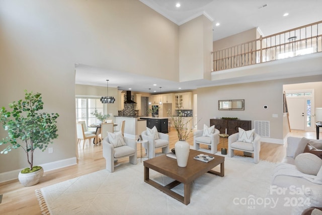 4023 Randolph Rd, Charlotte, NC 28211 - living room with recessed lighting, baseboards, light wood finished floors, a towering ceiling, and crown molding