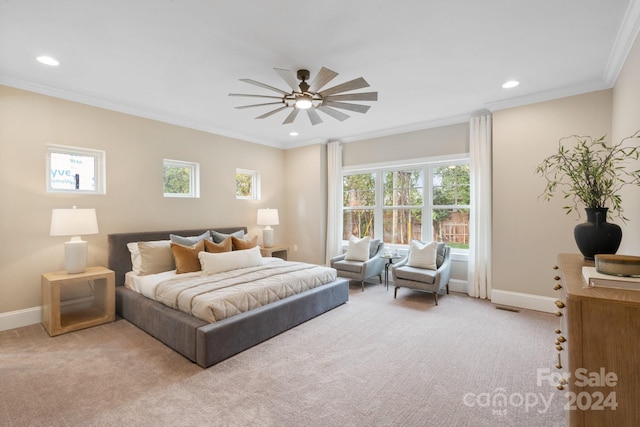 carpeted bedroom with multiple windows, ceiling fan, and ornamental molding