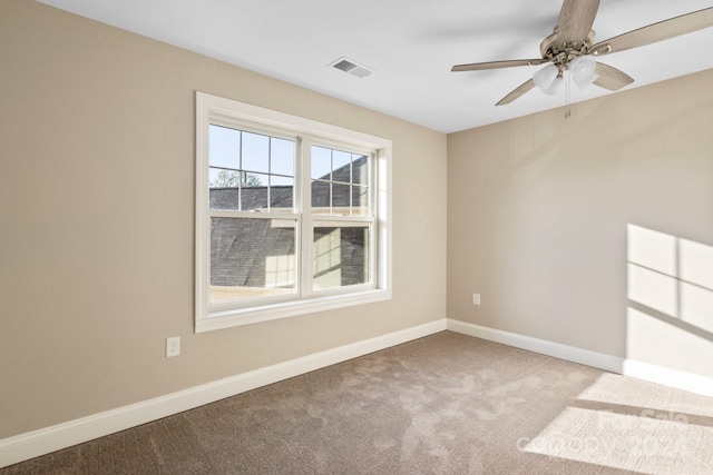 carpeted empty room featuring ceiling fan