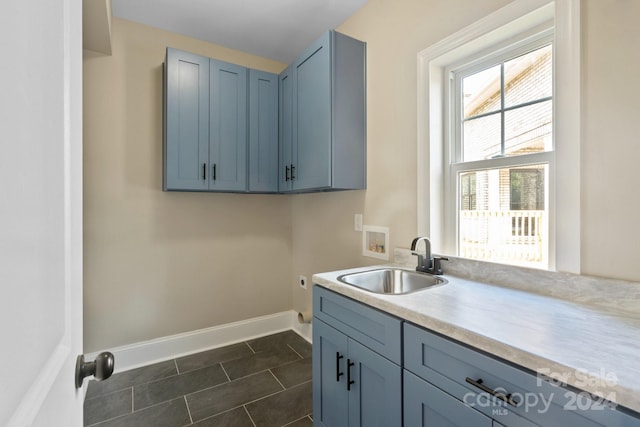 laundry room with cabinets, washer hookup, dark tile patterned floors, and sink