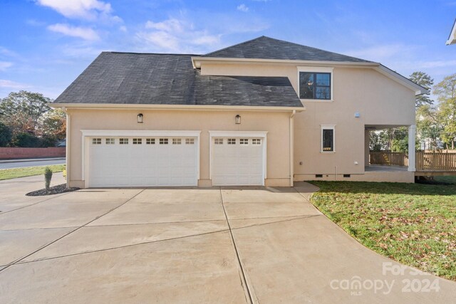 front facade with a garage and a front lawn