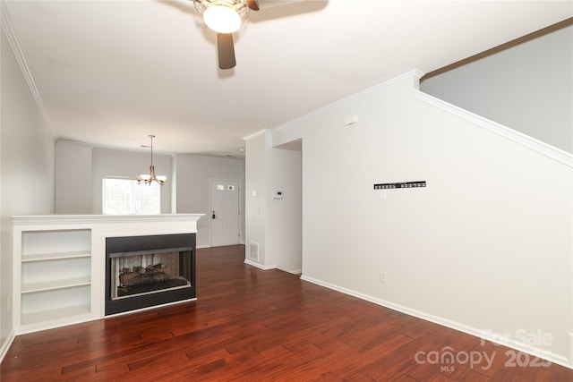 unfurnished living room with dark wood-style floors, crown molding, baseboards, a multi sided fireplace, and ceiling fan with notable chandelier