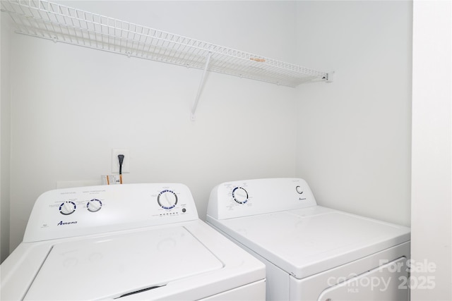 clothes washing area with laundry area and washer and clothes dryer