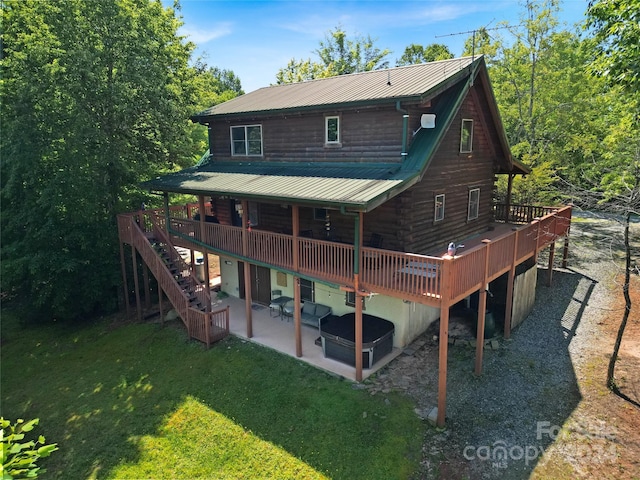 rear view of house featuring a patio area, a yard, and a deck